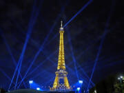 Search lights shine above Eiffel Tower Stadium, the beach volleyball venue at the 2024 Summer Olympics, Tuesday, July 30, 2024, in Paris, France. (AP Photo/Robert F.