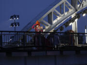 FILE - Drag queens prepare to perform on the Debilly Bridge in Paris, during the opening ceremony of the 2024 Summer Olympics, Friday, July 26, 2024. A storm of outrage about the Paris Olympics&rsquo; opening ceremony took a legal turn Tuesday July 30, 2024, with a DJ who performed at the show saying her lawyer is filing complaints over a torrent of threats and other abuse that the LGBTQ+ icon has suffered online in the ceremony&rsquo;s wake.