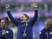 United States&#039; Ilona Maher, centre reacts as she stands on the podium with her bronze medal during the presentation ceremony Rugby Sevens at the 2024 Summer Olympics, in the Stade de France, in Saint-Denis, France, Tuesday, July 30, 2024.