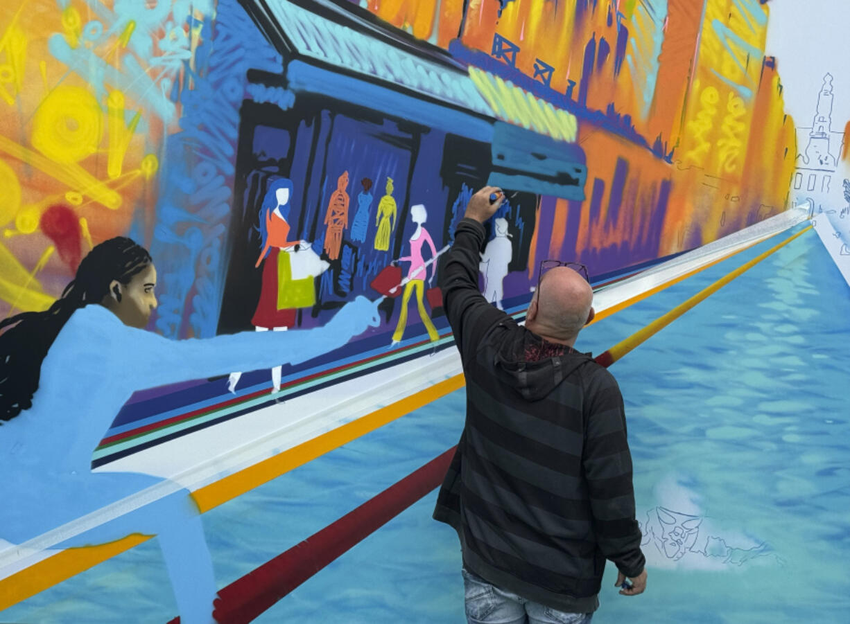 Street artist Marko93 works on a piece during a live artistic performance at City Hall, during the 2024 Summer Olympics, Wednesday, July 31, 2024, in Paris, France.