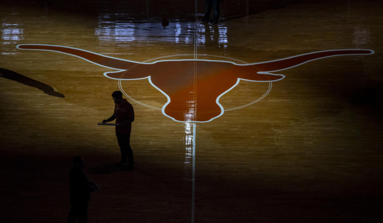 FILE -The University of Texas Longhorn silhouette is shown at the Frank Erwin Center during an NCAA college basketball game Jan. 16, 2021, in Austin, Texas.   Three years into the new age of college sports, where athletes are allowed to profit from their successes through name, image and likeness deals, everyone is still trying to find out what the new normal will be. (Ricardo B.