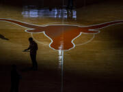 FILE -The University of Texas Longhorn silhouette is shown at the Frank Erwin Center during an NCAA college basketball game Jan. 16, 2021, in Austin, Texas.   Three years into the new age of college sports, where athletes are allowed to profit from their successes through name, image and likeness deals, everyone is still trying to find out what the new normal will be. (Ricardo B.