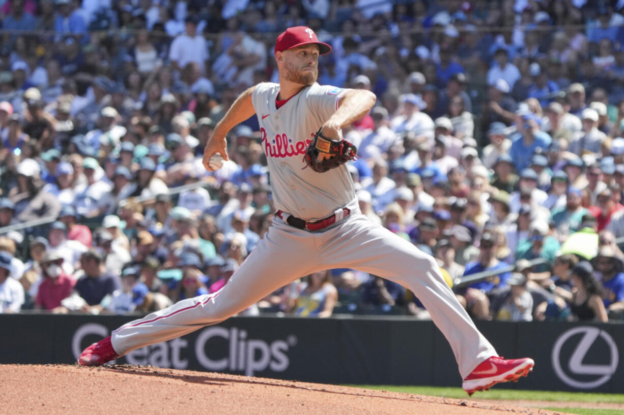 Philadelphia Phillies pitcher Zack Wheeler steps to throw a pitch during the first inning of a baseball game, Sunday, Aug. 4, 2024, in Seattle.