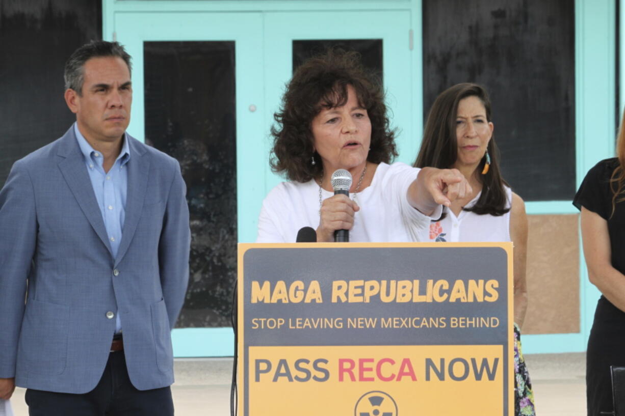 Tina Cordova, center, co-founder of the Tularosa Basin Downwinders Consortium, points to audience members who have been dealing with the consequences of radiation exposure, while politicians gathered for a news conference in Albuquerque, N.M., Tuesday, Aug. 13, 2024.