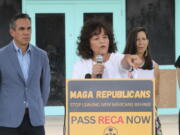 Tina Cordova, center, co-founder of the Tularosa Basin Downwinders Consortium, points to audience members who have been dealing with the consequences of radiation exposure, while politicians gathered for a news conference in Albuquerque, N.M., Tuesday, Aug. 13, 2024.