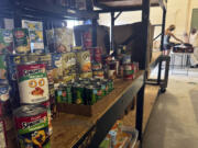 Stacks of donated goods line the shelves at the Good News Outreach food bank, Wednesday, July 31, 2024, in Tallahassee, Fla. Florida is one of 13 states that is not participating in a federal hunger relief program this summer that helps families in need buy groceries.