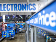 FILE - People walk around a Walmart Superstore in Secaucus, New Jersey, on July 11, 2024.