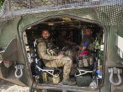 FILE - Ukrainian servicemen sit in their armored personnel carrier in Ukraine&rsquo;s Sumy region on Aug. 14, 2024, after returning from Russia&rsquo;s Kursk region.