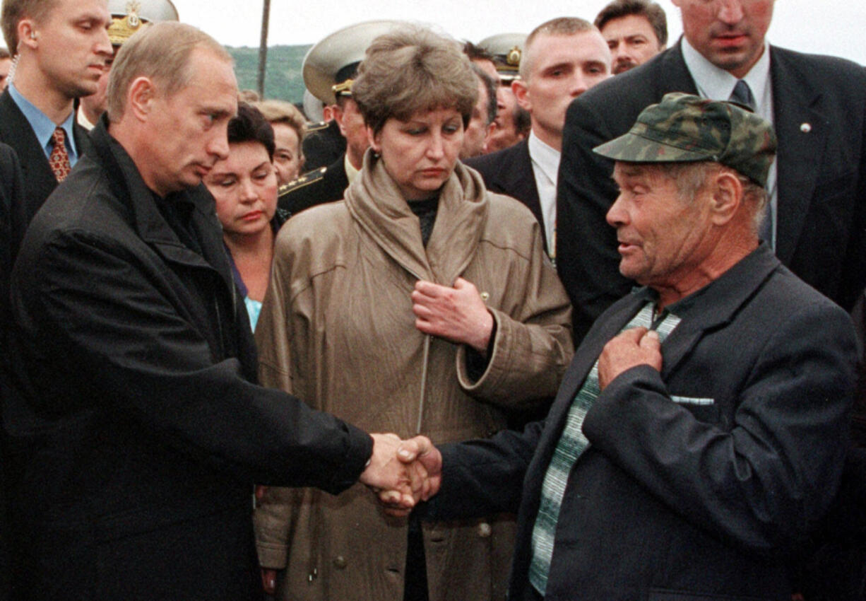 FILE - Russian President Vladimir Putin greets an unidentified relative of a seaman who was believed killed aboard the nuclear submarine Kursk at the military base of Vedyayevo, 50 miles (80 kilometers) north of Murmansk, Russia, on Aug. 22, 2000.