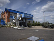 A Ukrainian army armored personnel carrier drives past a gas metering station of the Russian energy giant Gazprom in Sudzha, in Russia&rsquo;s Kursk region, on Friday.