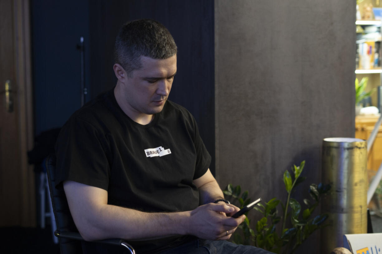 Ukraine&rsquo;s Deputy Prime Minister of Innovations and Technology Mykhailo Fedorov looks at his phone after an interview with The Associated Press in Kyiv, Ukraine, Monday, Aug. 19, 2024.