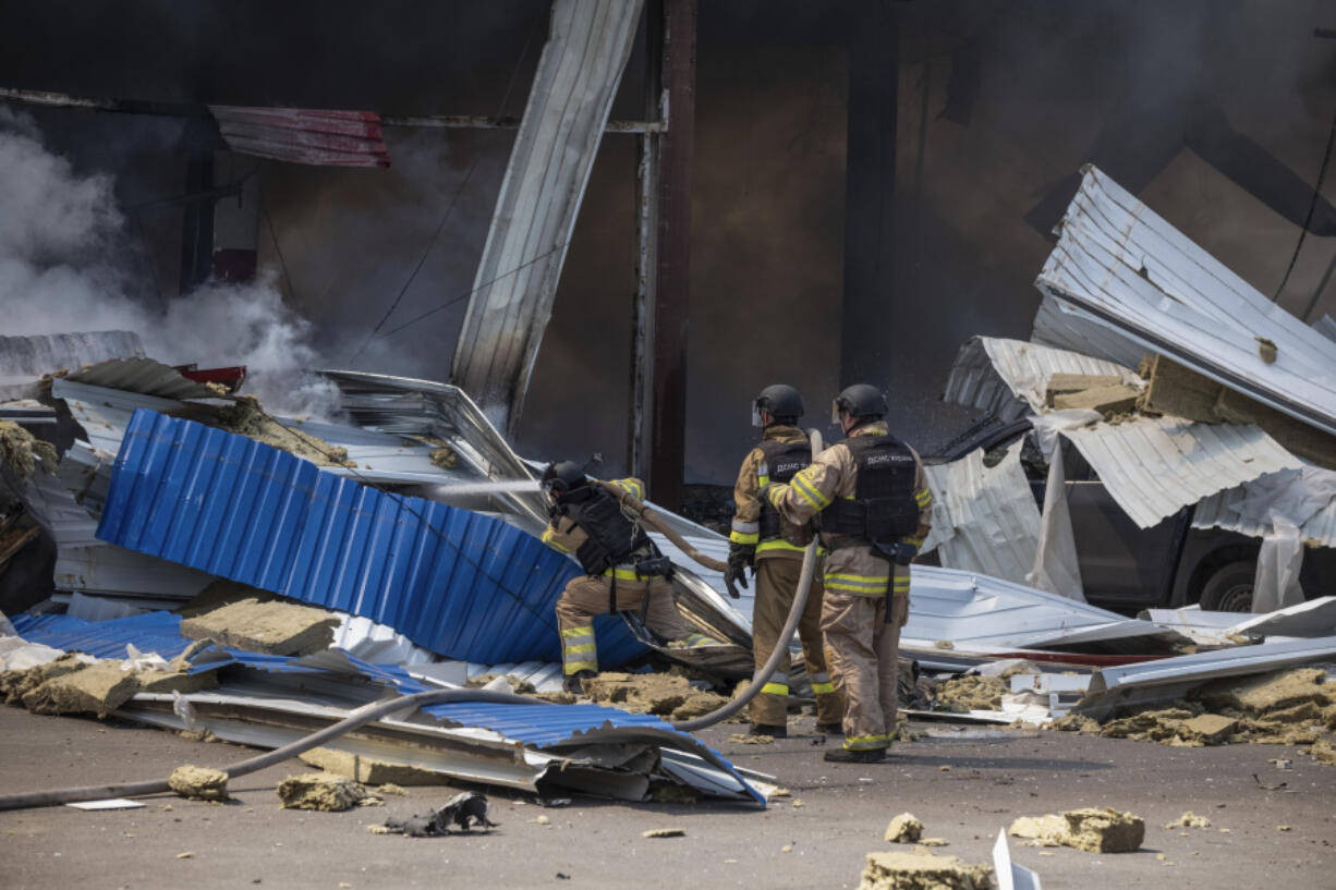 Firefighters extinguish the fire after a Russian missile hit a supermarket in Kostiantynivka, Donetsk region, Ukraine, Friday, Aug. 9, 2024.