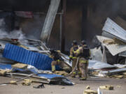 Firefighters extinguish the fire after a Russian missile hit a supermarket in Kostiantynivka, Donetsk region, Ukraine, Friday, Aug. 9, 2024.