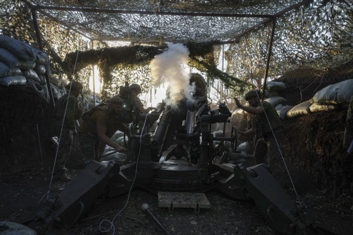 Ukrainian servicemen of 148th separate artillery brigade of the Air Assault Forces fire towards Russian positions by a M777 howitzer at the frontline in Donetsk region, Ukraine, Wednesday, August 21, 2024.