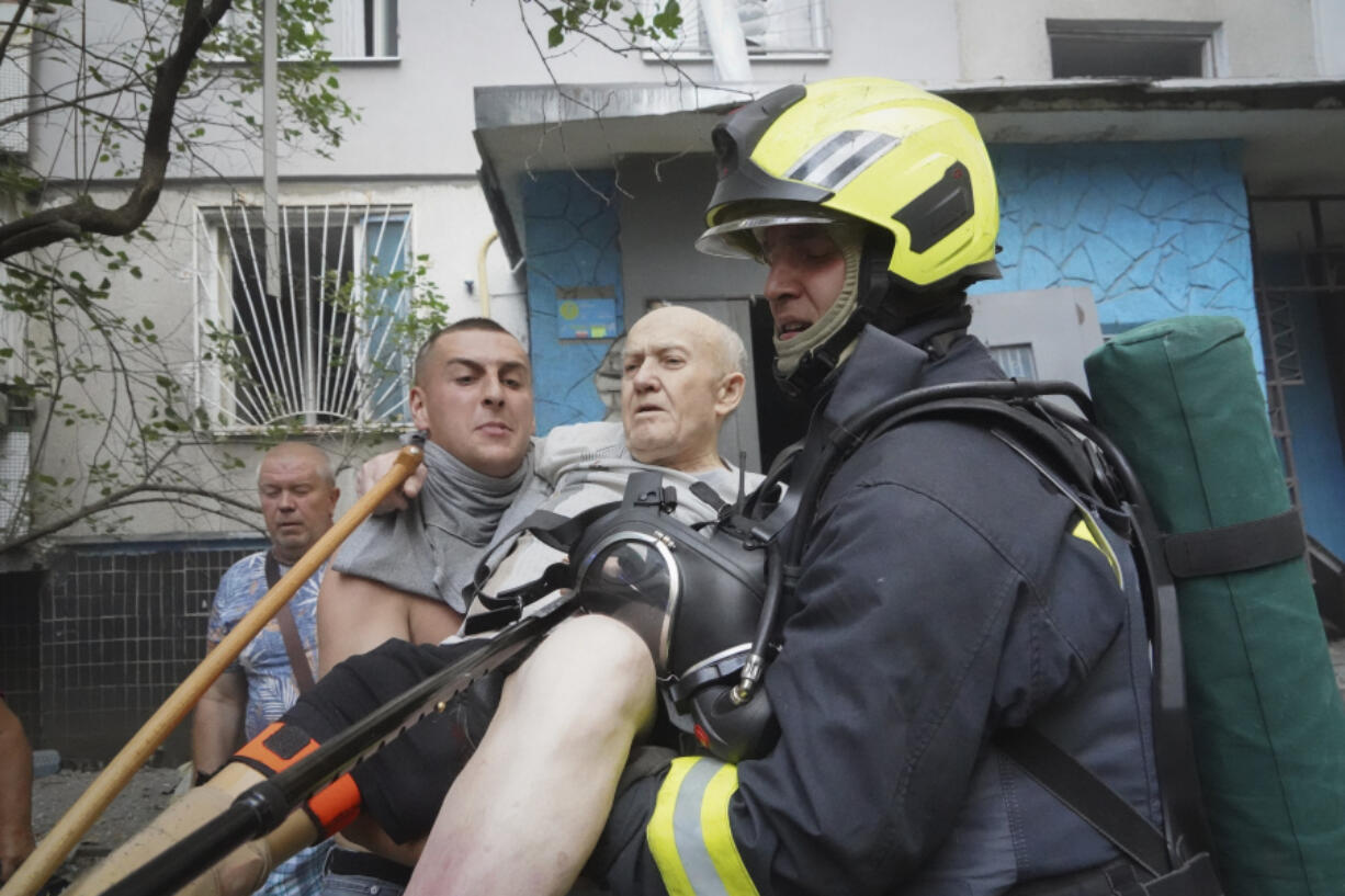 Rescuers carry a disabled elderly resident after the Russia&#039;s guided air bomb hit an apartment building in Kharkiv, Ukraine, Friday, Aug. 30, 2024. Russian attack on the northeastern city of Kharkiv using powerful plane-launched glide bombs killed five people, including a 14-year-old girl on a playground, and wounded 47 others, regional Gov. Oleh Syniehubov said.