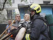 Rescuers carry a disabled elderly resident after the Russia&#039;s guided air bomb hit an apartment building in Kharkiv, Ukraine, Friday, Aug. 30, 2024. Russian attack on the northeastern city of Kharkiv using powerful plane-launched glide bombs killed five people, including a 14-year-old girl on a playground, and wounded 47 others, regional Gov. Oleh Syniehubov said.