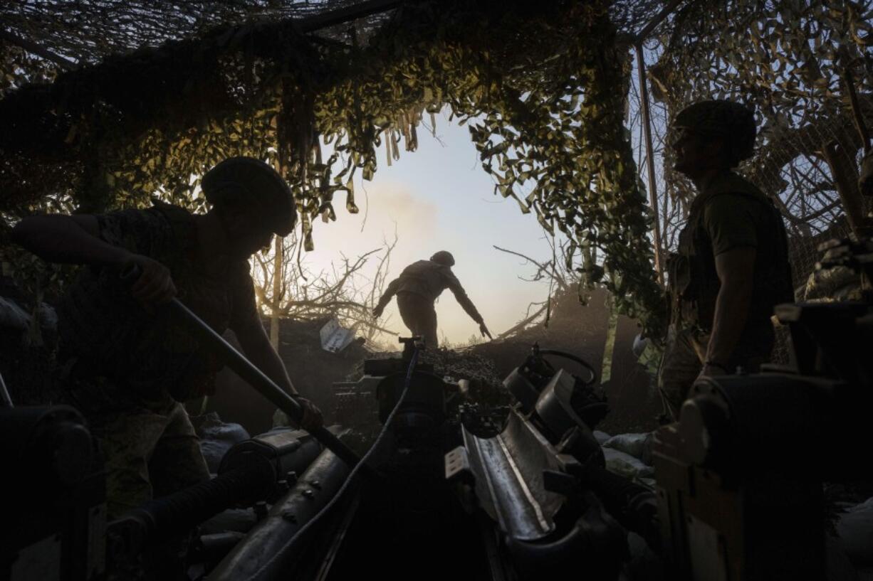 Ukrainian servicemen of 148th separate artillery brigade of the Air Assault Forces prepare M777 howitzer to fire towards Russian positions at the frontline in Donetsk region, Ukraine, Wednesday, August 21, 2024.