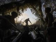 Ukrainian servicemen of 148th separate artillery brigade of the Air Assault Forces prepare M777 howitzer to fire towards Russian positions at the frontline in Donetsk region, Ukraine, Wednesday, August 21, 2024.