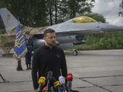 Ukraine&#039;s President Volodymyr Zelenskyy answers media questions standing against the background of Ukraine&#039;s Air Force&#039;s F-16 fighter jets in an undisclosed location in Ukraine, Sunday, Aug. 4, 2024. The F-16 fighter jets that have been delivered to Ukraine by Western countries will be flying sorties in Ukrainian skies and helping the country&#039;s current fleet of Soviet-era jets to counter Russia&#039;s invasion.