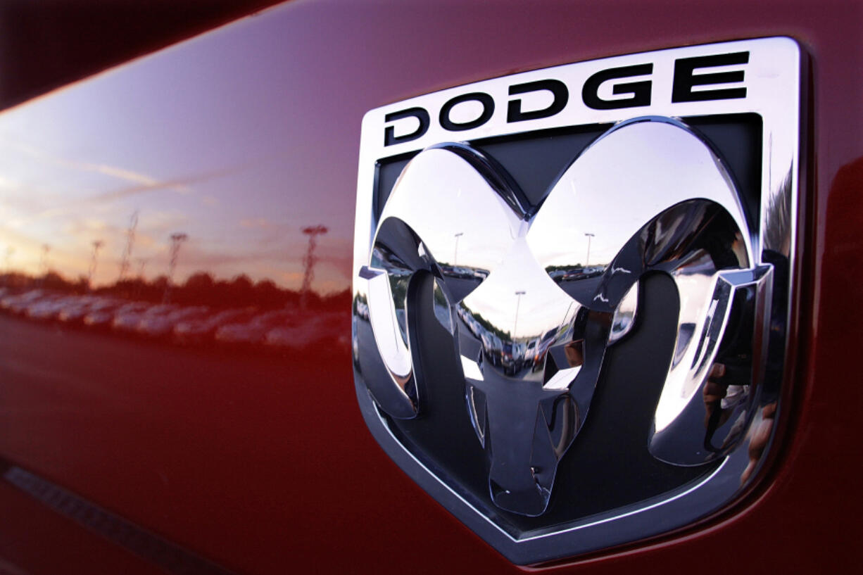 FILE - The Dodge logo is seen on a new Dodge RAM 3500 Heavy Duty pickup truck at a dealership in Springfield, Ill., Aug. 15, 2010. U.S. auto safety regulators are a step closer to seeking a recall of nearly a million Dodge Journey SUVs after a woman was trapped and died when her vehicle caught fire in 2022. The agency says in documents posted on its website Friday, Aug. 2, 2024, that it now has 19 complaints that inoperative door locks and windows can prevent people from getting out of the small SUVs during an emergency.