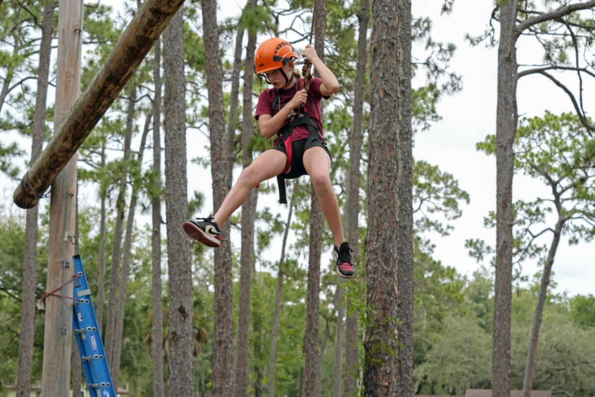 Sienna Camp, 10, slowly descends from the high rope obstacle course at the Florida Sheriff&rsquo;s Youth Ranch Thursday, Aug. 1, 2024, in Pierson, Fla.