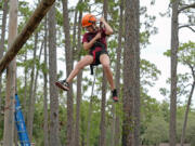 Sienna Camp, 10, slowly descends from the high rope obstacle course at the Florida Sheriff&rsquo;s Youth Ranch Thursday, Aug. 1, 2024, in Pierson, Fla.