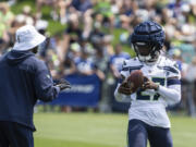 Seattle Seahawks defensive back Riq Woolen catches the ball during practice at NFL football training camp, Saturday, July 27, 2024, in Renton, Wash.