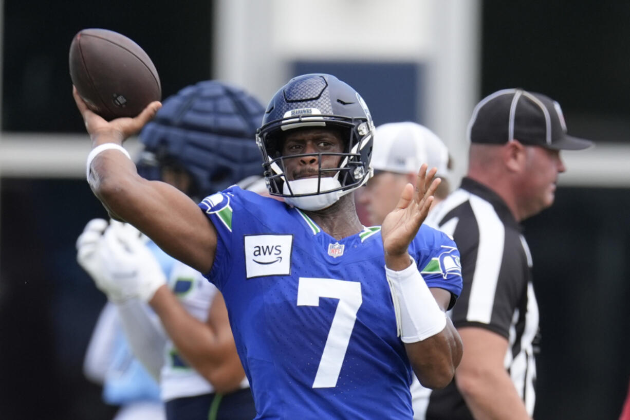 Seattle Seahawks quarterback Geno Smith (7) throws a pass during an NFL joint football training camp practice with the Tennessee Titans, Wednesday, Aug. 14, 2024, in Nashville, Tenn.