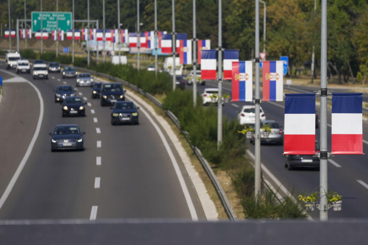 French and Serbian flags fly on lampposts on a highway in Belgrade, Serbia, Thursday, Aug. 29, 2024, ahead of French President Emmanuel Macron two-day state visit to Serbia.