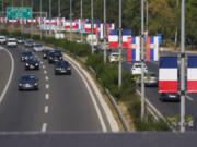 French and Serbian flags fly on lampposts on a highway in Belgrade, Serbia, Thursday, Aug. 29, 2024, ahead of French President Emmanuel Macron two-day state visit to Serbia.