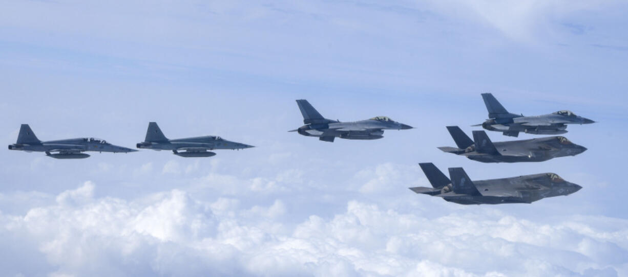 In this photo provided by the South Korean Defense Ministry, U.S. Marine F-35B fighter jets, right bottom, South Korean Air Force KF-16 fighter jets and F-5 fighter jets, left, fly over the Korean Peninsula during a joint air drill over South Korea, Wednesday, July 24, 2024.