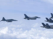 In this photo provided by the South Korean Defense Ministry, U.S. Marine F-35B fighter jets, right bottom, South Korean Air Force KF-16 fighter jets and F-5 fighter jets, left, fly over the Korean Peninsula during a joint air drill over South Korea, Wednesday, July 24, 2024.