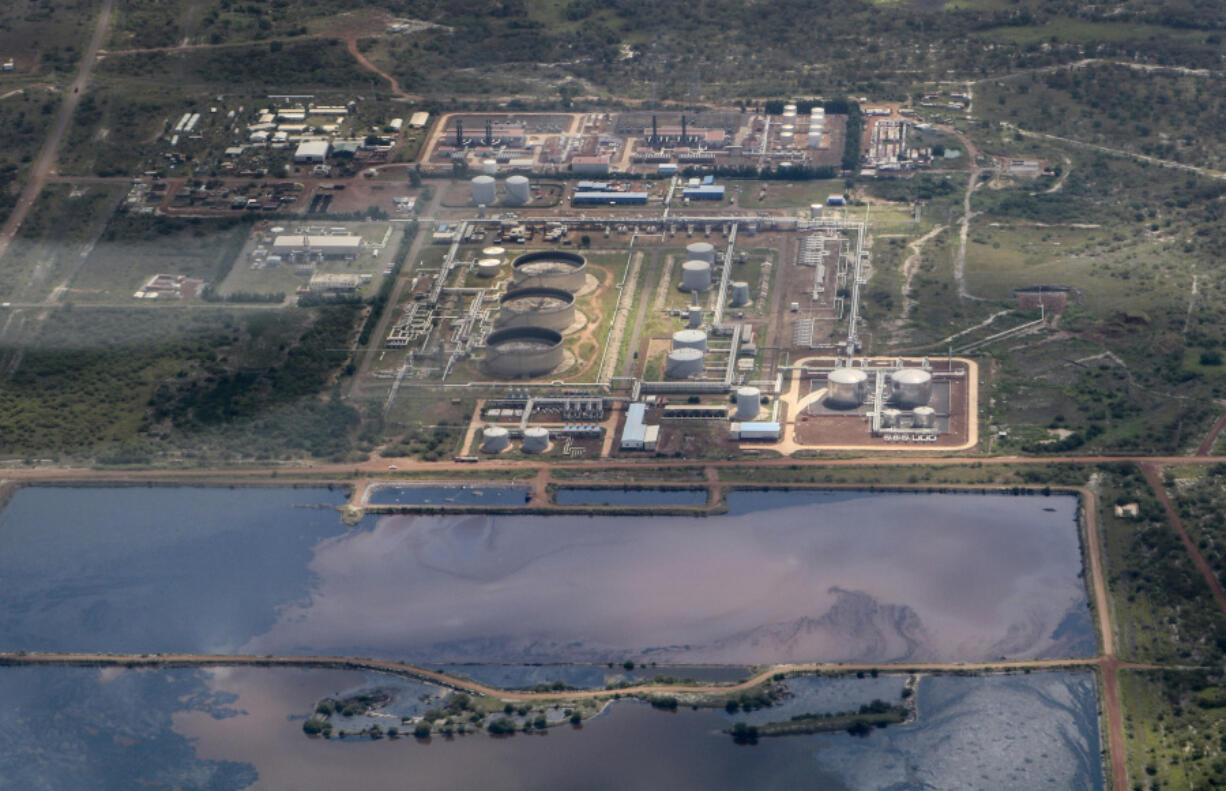 FILE - A reservoir of polluted water lies next to an oil field, seen from the air, in Paloch, South Sudan on Sept. 27, 2018.