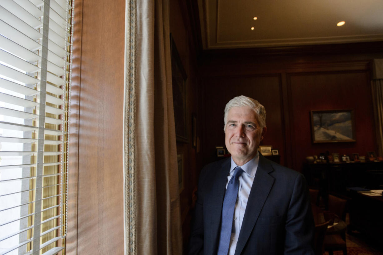 Supreme Court Justice Neil Gorsuch stands in his office July 29 at the Supreme Court in Washington. Gorsuch is out with a new book in which he says ordinary Americans are &ldquo;getting whacked&rdquo; by too many laws and regulations.