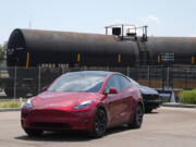 FILE - Drivers guide 2024 a Tesla Model 3 sedan and Model X utility vehicle, rear, along a test track at the Electrify Expo in The Yards on July 14, 2024, in north Denver.