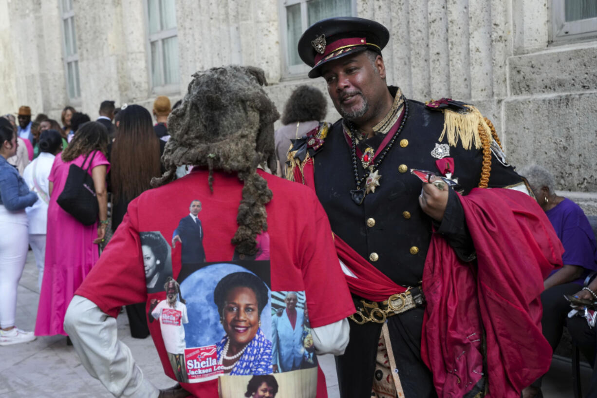 Ben Burns talks with a man named Motapa as they wait to pay their respects to the late Rep. Sheila Jackson Lee as she lies in state Monday, July 29, 2024, at Houston City Hall in Houston.