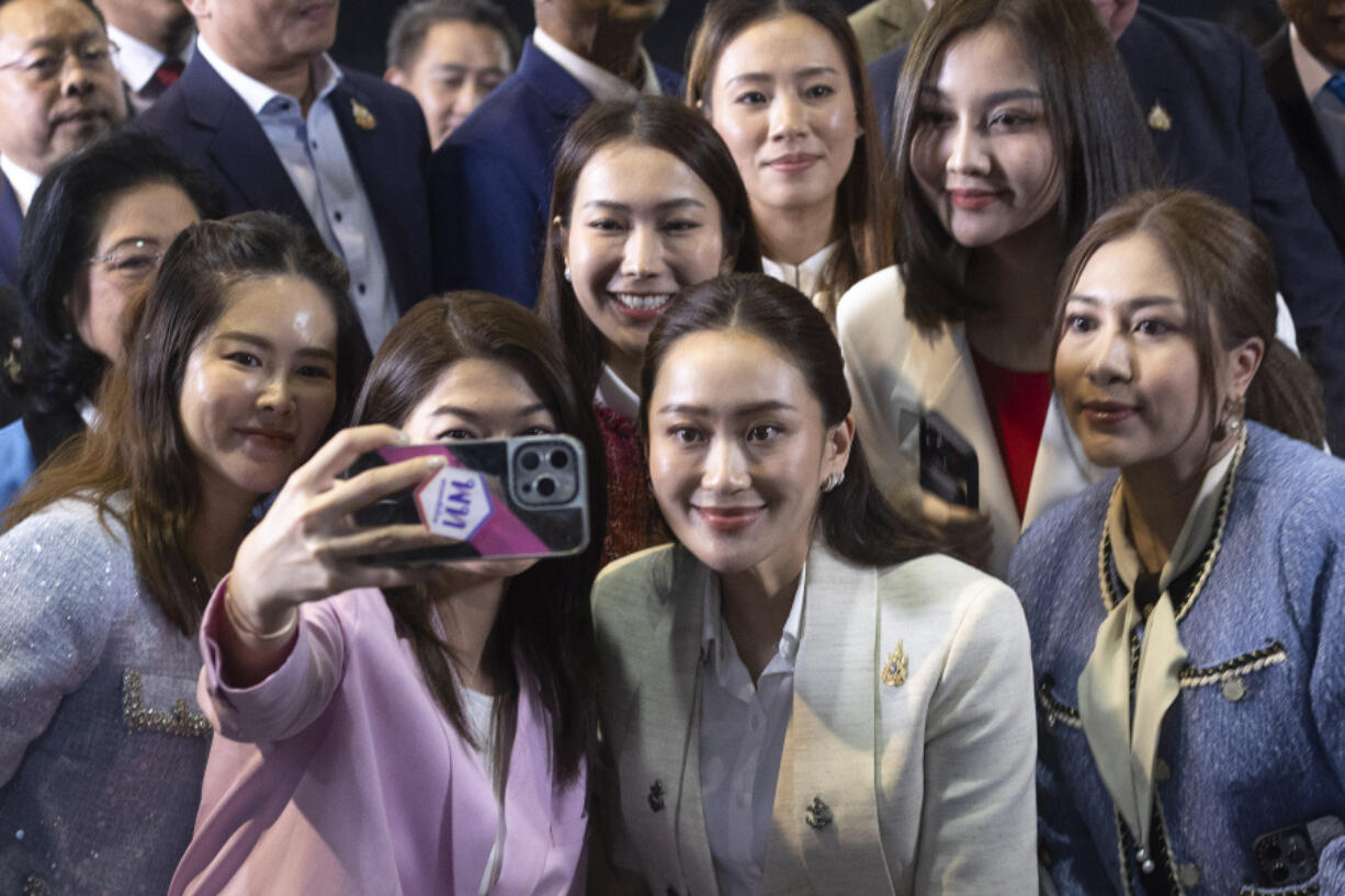 Thailand&rsquo;s newly elected Prime Minister Paetongtarn Shinawatra, center right in front, poses  for a selfie with members of her Pheu Thai party, following a press conference at their party&rsquo;s headquarters in Bangkok, Thailand after Thailand&rsquo;s Parliament elected Paetongtarn  as prime minister Friday, Aug. 16, 2024.