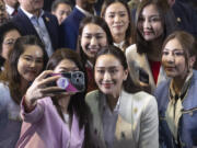 Thailand&rsquo;s newly elected Prime Minister Paetongtarn Shinawatra, center right in front, poses  for a selfie with members of her Pheu Thai party, following a press conference at their party&rsquo;s headquarters in Bangkok, Thailand after Thailand&rsquo;s Parliament elected Paetongtarn  as prime minister Friday, Aug. 16, 2024.