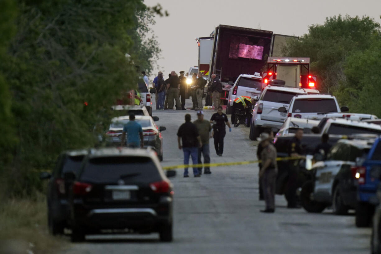 FILE - Police and other first responders work the scene where officials say dozens of people have been found dead and multiple others were taken to hospitals with heat-related illnesses after a tractor-trailer containing suspected migrants was found on June 27, 2022, in San Antonio.