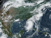 This satellite image provided by NOAA shows Tropical Storm Debby as it moves through the Gulf of Mexico toward Florida on Sunday, Aug. 4, 2024.