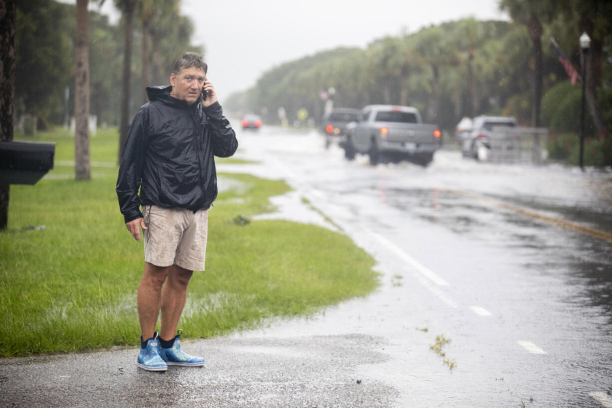 City of Isle of Palms councilman John Bogosian calls local officials informing them flooding water on Palm Blvd as Tropical Storm Debby approaches, Tuesday, Aug. 6, 2024, in Isle of Palms, S.C.