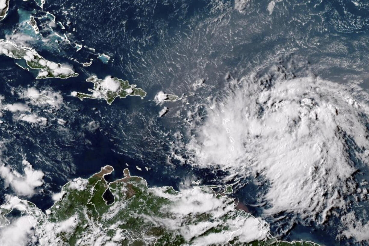 This GOES-16 GeoColor satellite image taken at 4:30 p.m. EDT and provided by National Oceanic and Atmospheric Administration (NOAA) shows Tropical Storm Ernesto over the Atlantic Ocean and moving west-northwest toward the Lesser Antilles, Monday, Aug. 12, 2024.