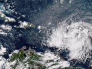 This GOES-16 GeoColor satellite image taken at 4:30 p.m. EDT and provided by National Oceanic and Atmospheric Administration (NOAA) shows Tropical Storm Ernesto over the Atlantic Ocean and moving west-northwest toward the Lesser Antilles, Monday, Aug. 12, 2024.