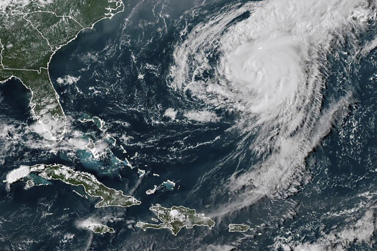 This GOES-16 GeoColor satellite image taken at 4:40 p.m EDT and provided by National Oceanic and Atmospheric Administration (NOAA) shows Hurricane Ernesto in the Atlantic Ocean south-southwest of Bermuda, Friday, Aug. 16, 2024.