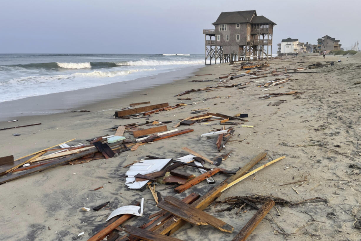 Debris from an unoccupied house that collapsed into the Atlantic Ocean from winds and waves caused by Tropical Storm Ernesto litters the beach Friday in Rodanthe, N.C., along the Cape Hatteras National Seashore.