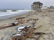 Debris from an unoccupied house that collapsed into the Atlantic Ocean from winds and waves caused by Tropical Storm Ernesto litters the beach Friday in Rodanthe, N.C., along the Cape Hatteras National Seashore.