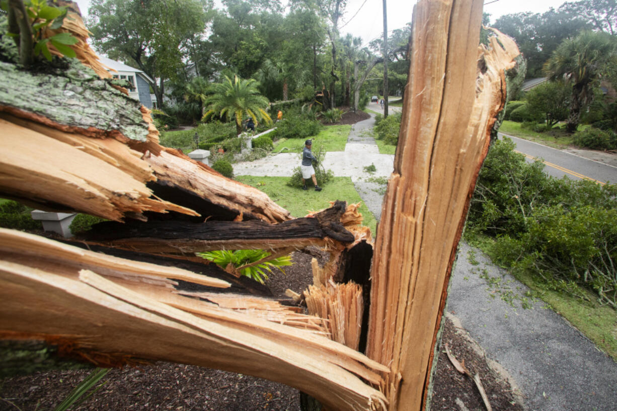 A worker cleans debris from a possible tornado as an outer band from Tropical Storm Debby passed over the Isle of Palms, S.C., Tuesday, Aug. 6, 2024.