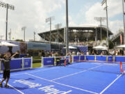 Ten-year-old Jack Jacobs serves to Jack Balsam, 11, as they play a version of tennis resembling pickleball on the grounds of the Billie Jean King National Tennis Center during the first round of the U.S. Open tennis championships, Monday, Aug. 26, 2024, in New York.