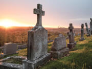 FILE - The sun rises on St. Mary&rsquo;s Cemetery, April 19, 2019, in McKees Rocks, Pa.