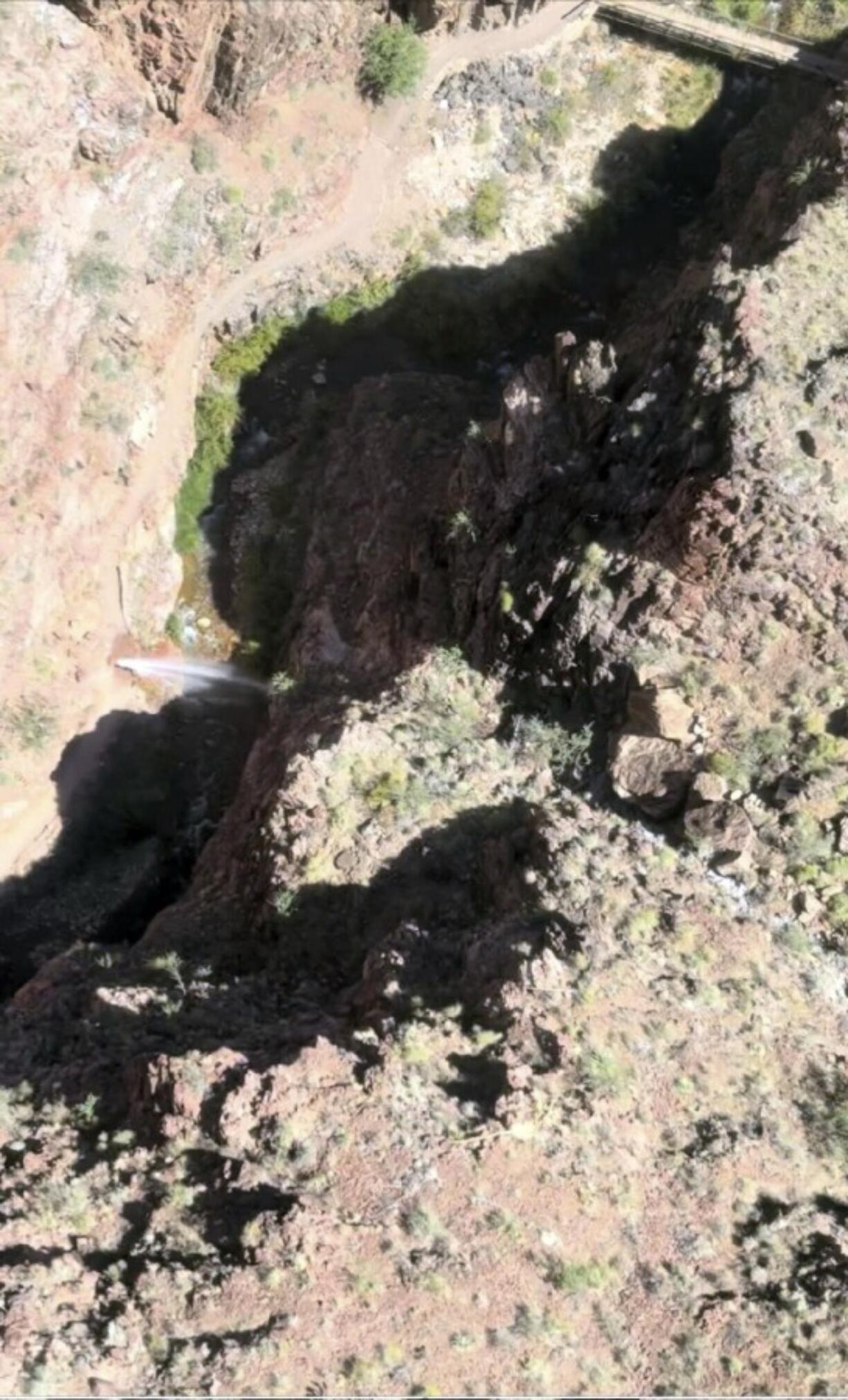 In this photo provided by the National Park Service, water shoots out of a pipeline that broke along the North Kaibab Trail on Aug. 20, 2024 at Grand Canyon National Park, Ariz.